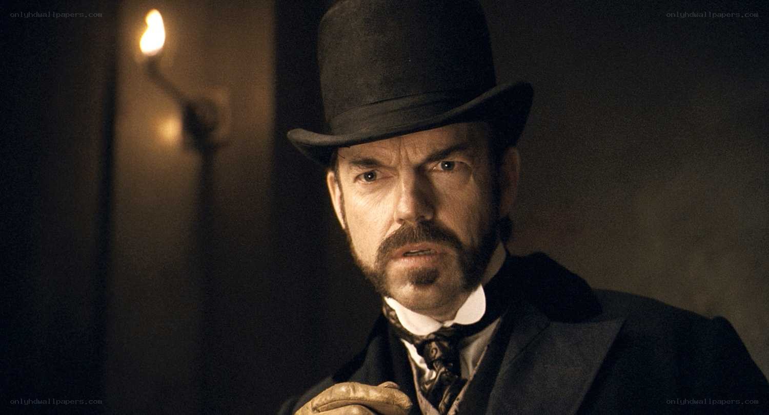 man in top hat looking serious