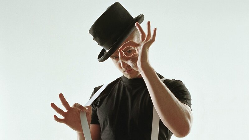 man in top hat making hand gesture