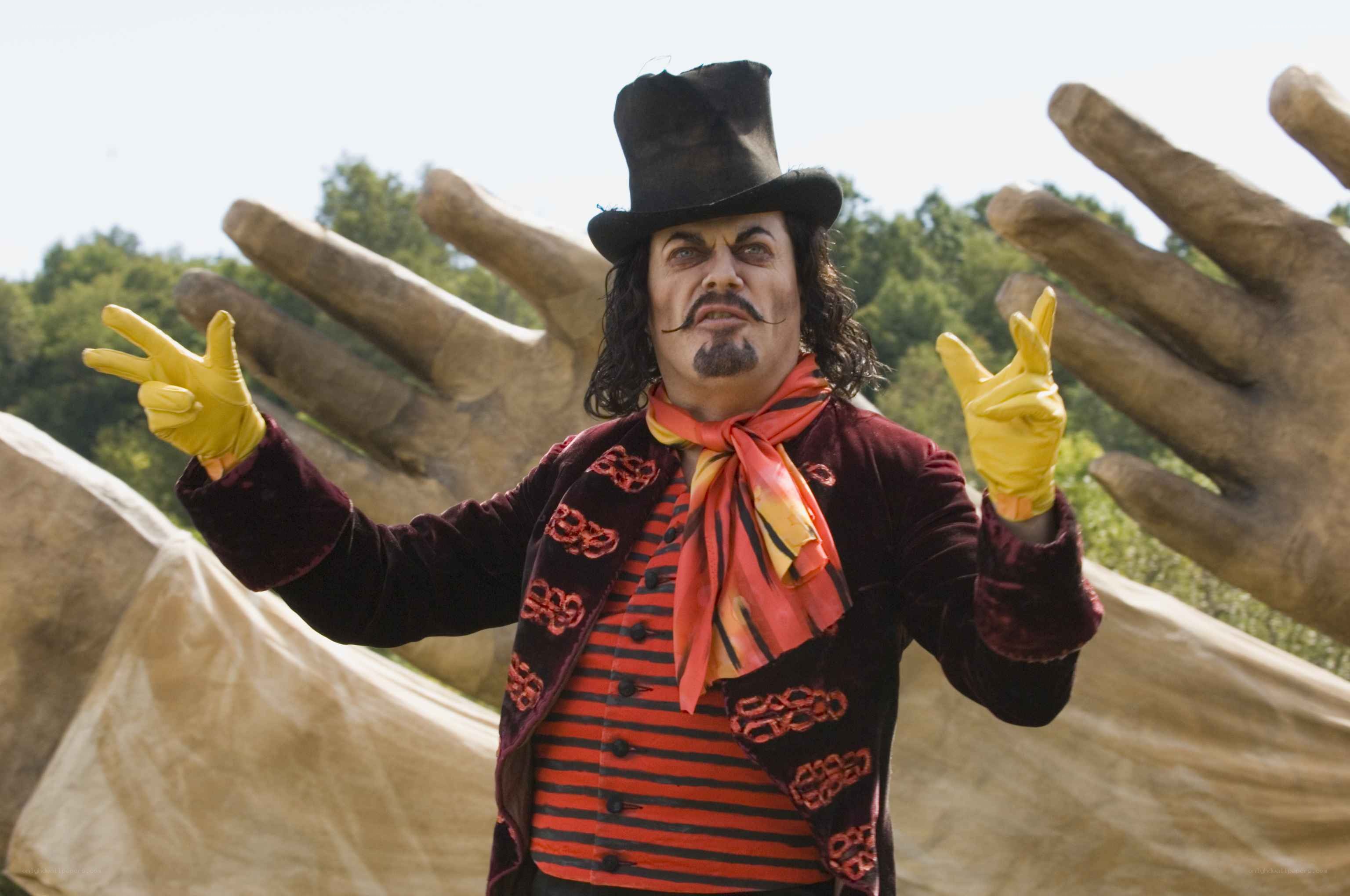 man in top hat with giant hands