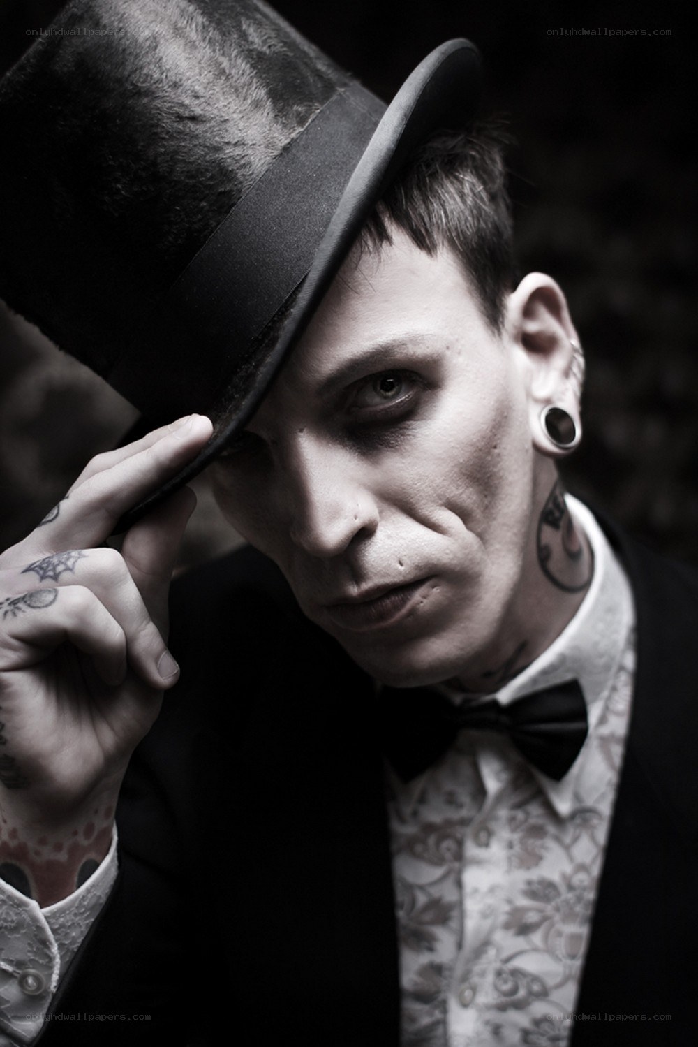 man in top hat with tattoos