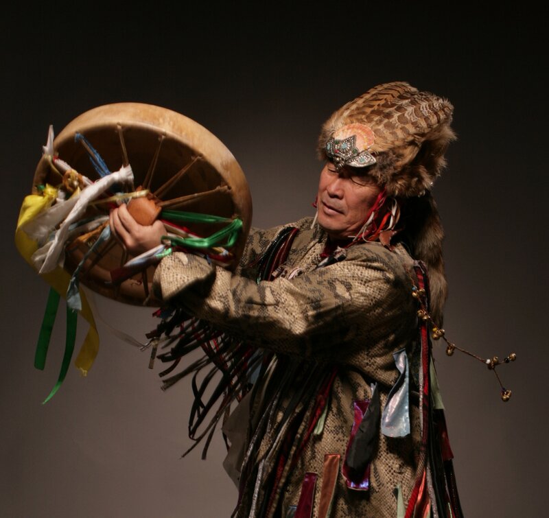Man in traditional attire playing drum