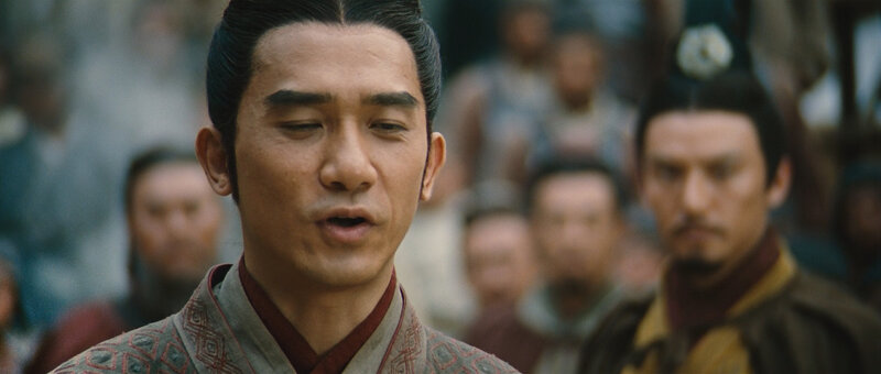 man in traditional clothing speaking