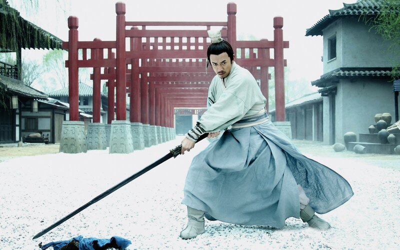 man in traditional clothing with sword