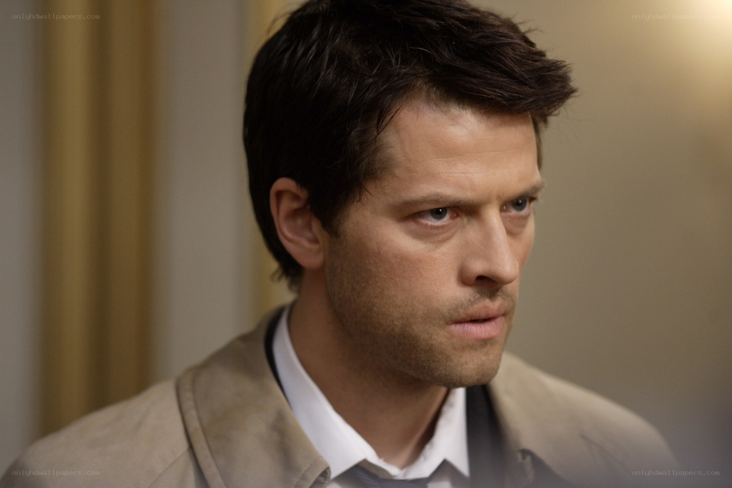 man in trench coat looking serious