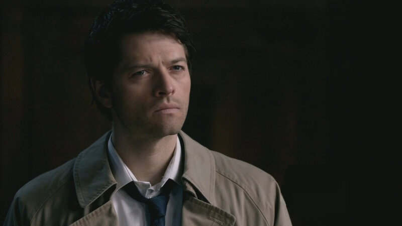 man in trench coat looking serious