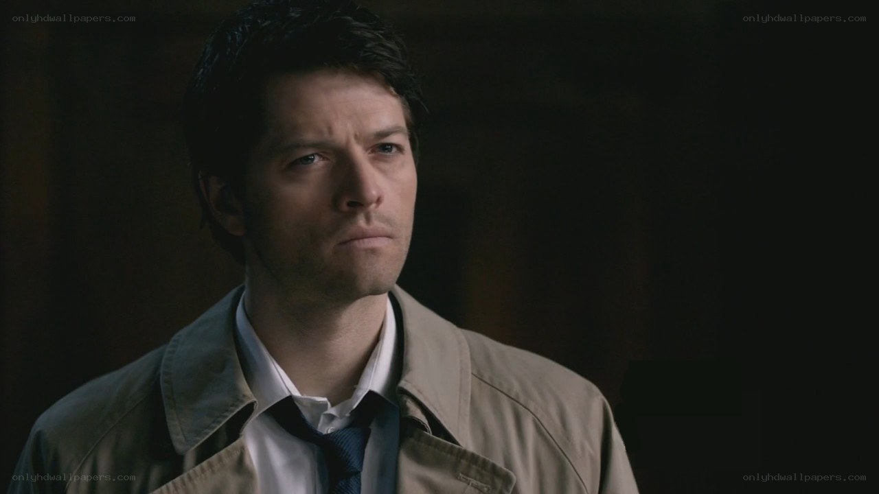 man in trench coat looking serious