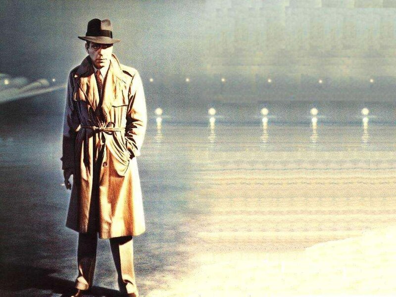 man in trench coat on beach