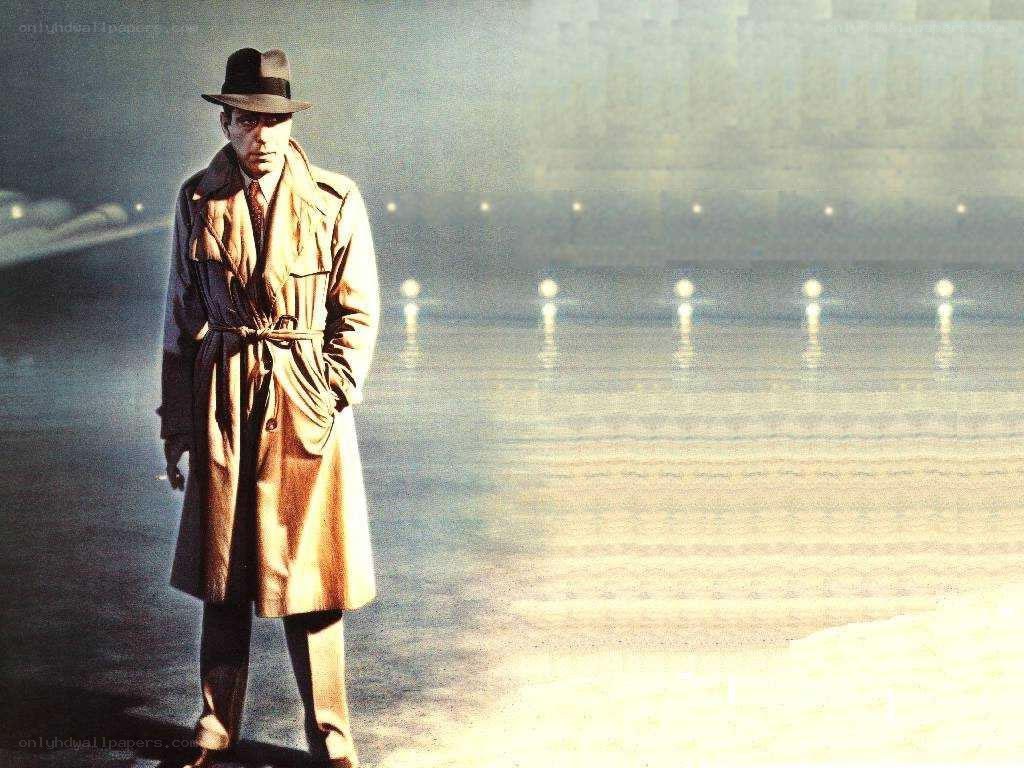 man in trench coat on beach