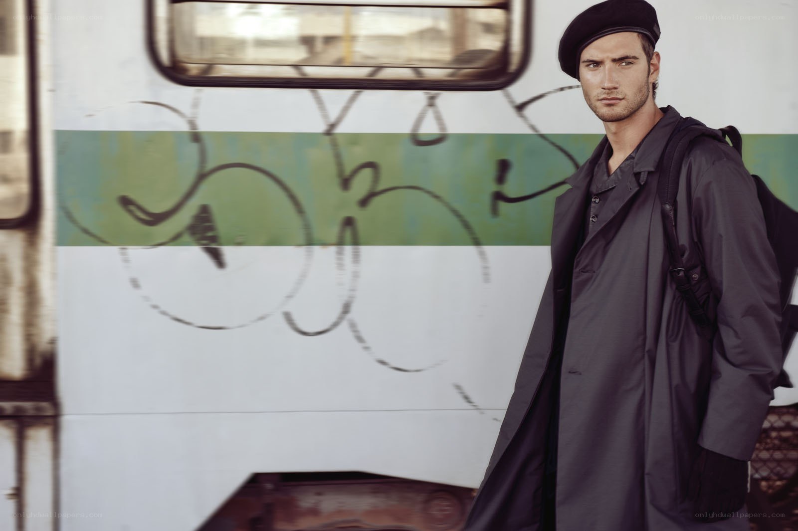 man in trench coat with backpack
