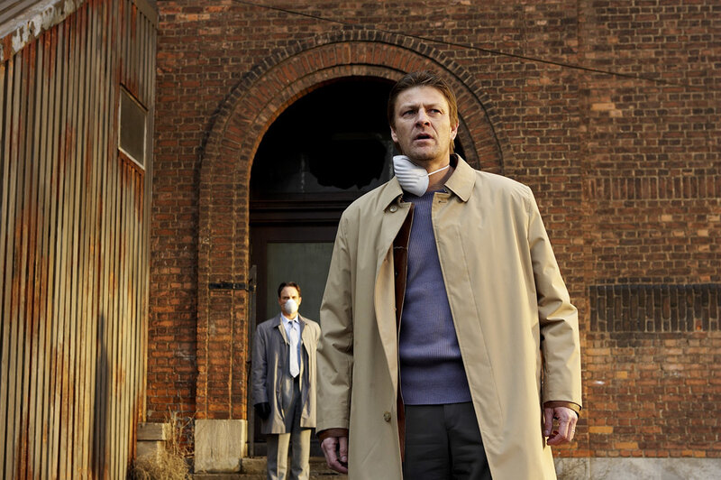 Man in trench coat with mask