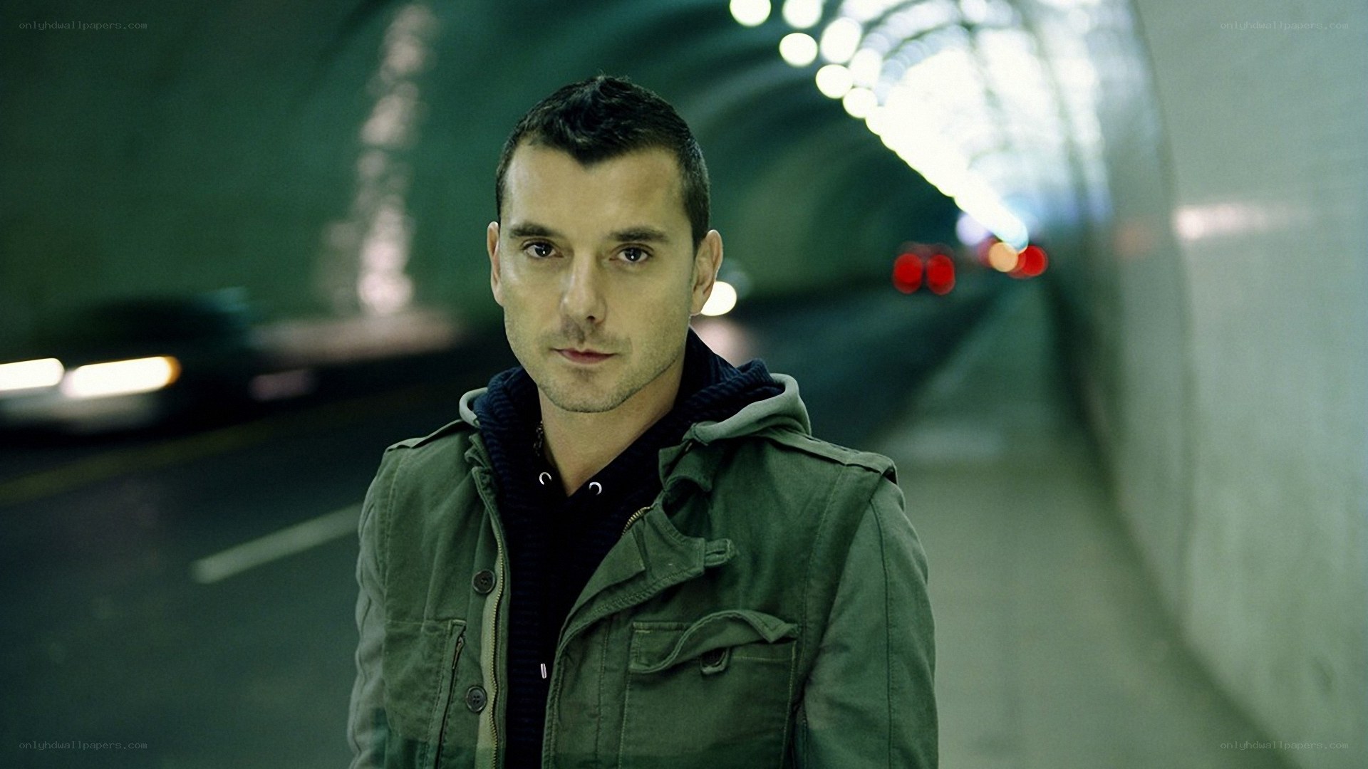 man in tunnel wearing jacket