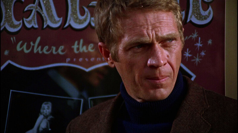 man in turtleneck looking serious