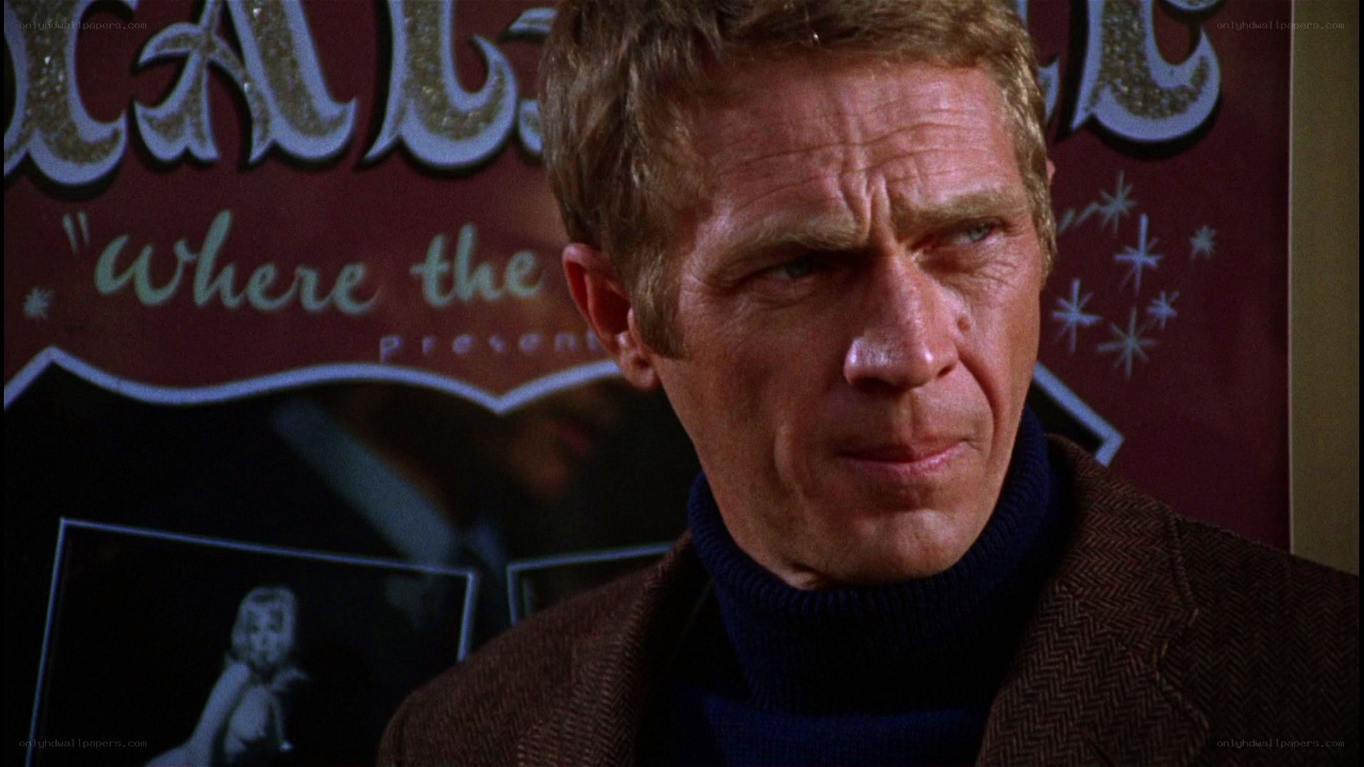 man in turtleneck looking serious