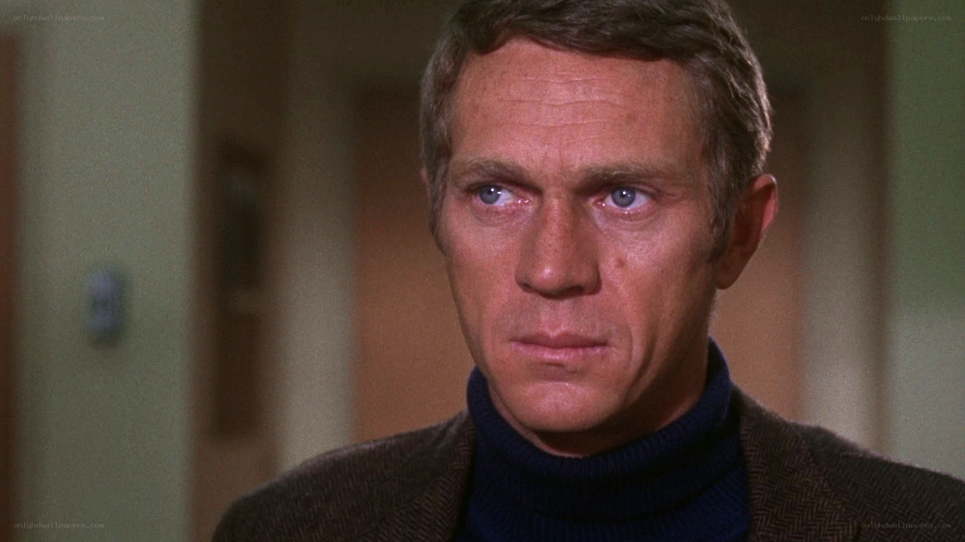 man in turtleneck looking serious