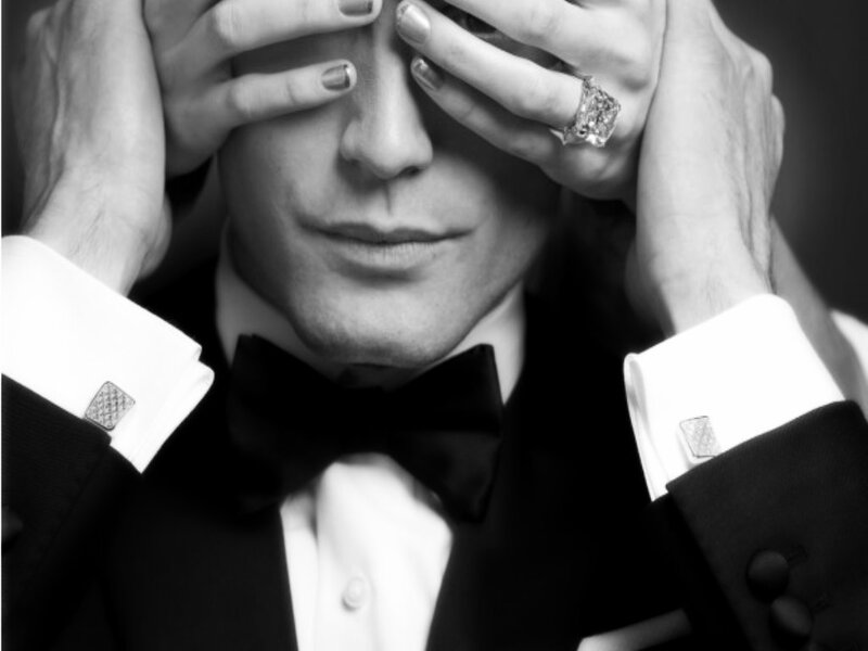 Man in Tuxedo Covering Eyes
