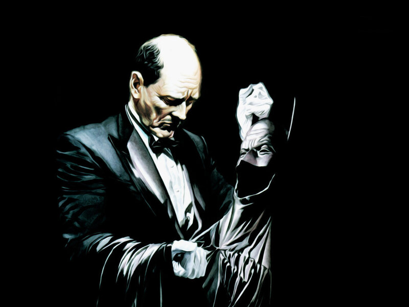 Man in Tuxedo Holding Mask