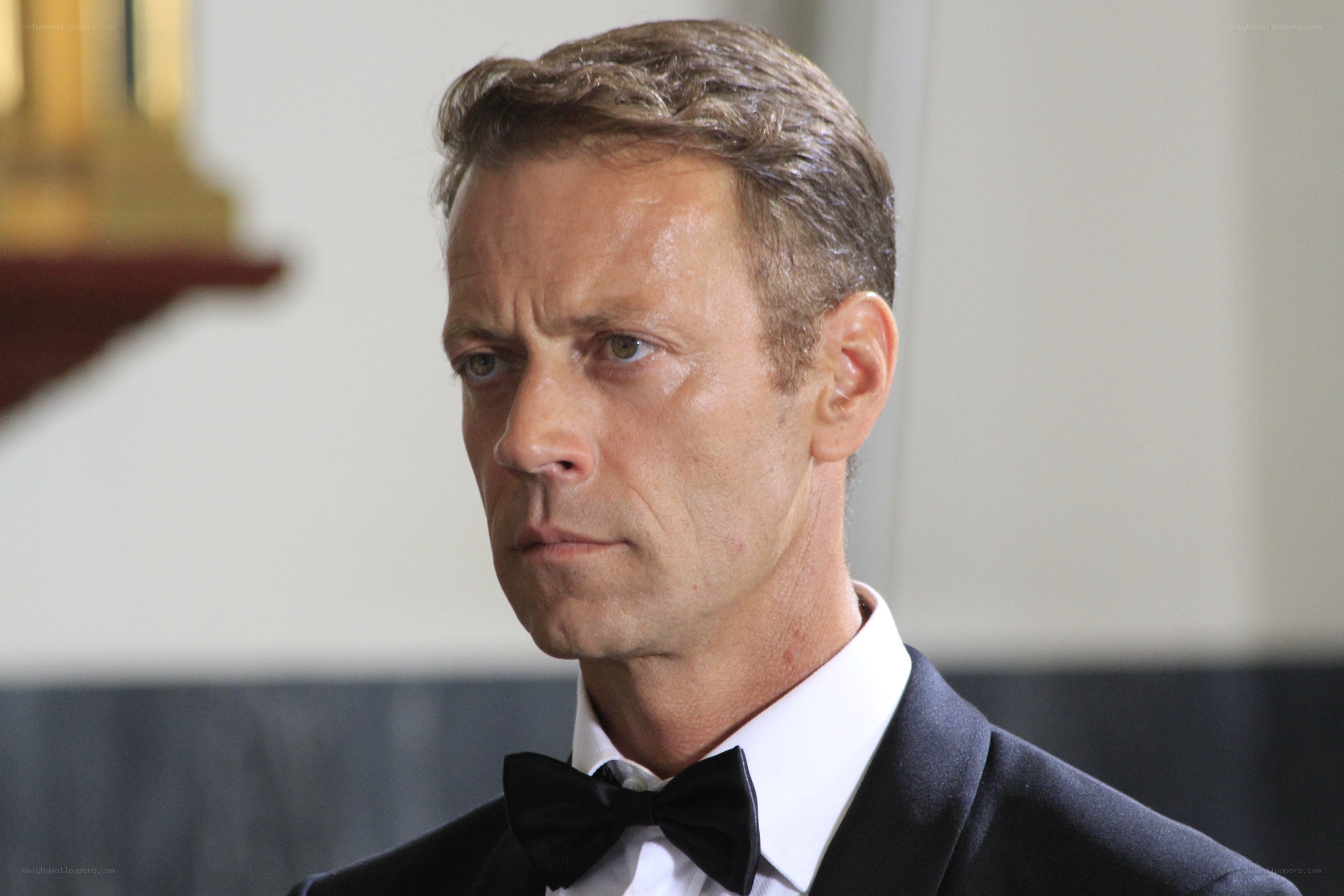 man in tuxedo looking serious