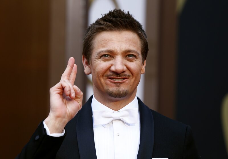 man in tuxedo making peace sign