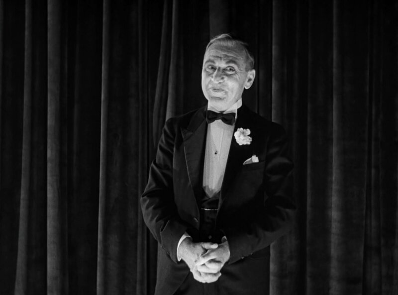 Man in tuxedo on stage