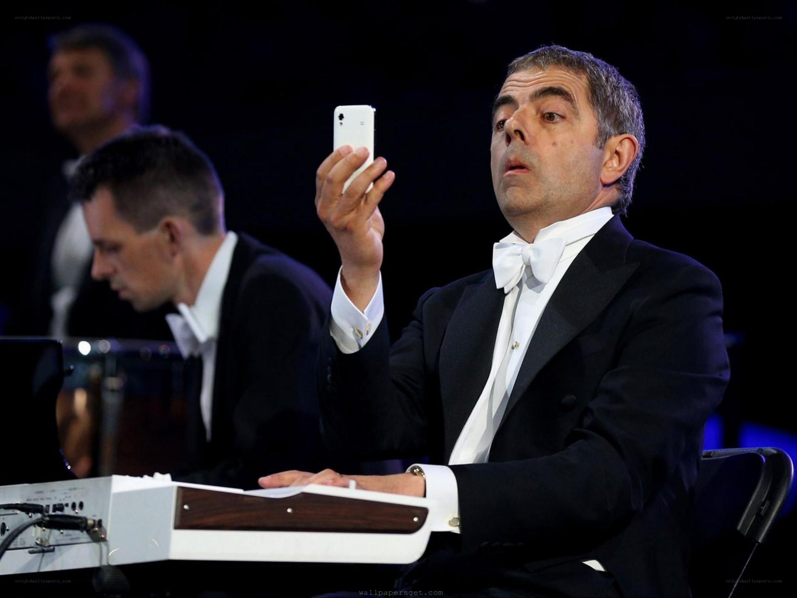 Man in tuxedo using smartphone