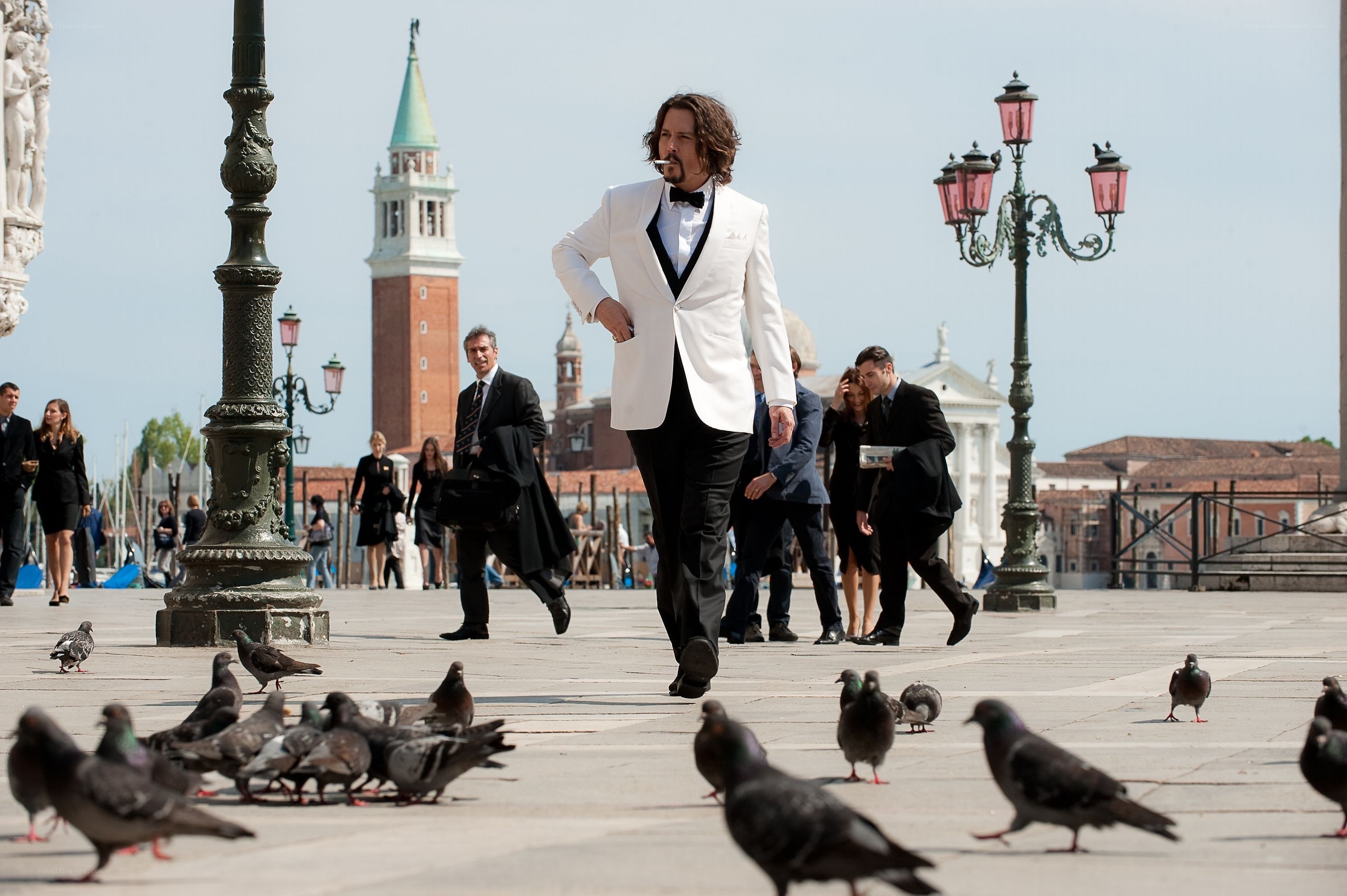 Man in tuxedo walking through square