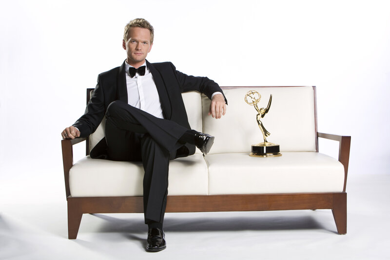 Man in tuxedo with Emmy award