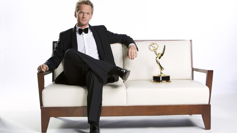 Man in tuxedo with Emmy award