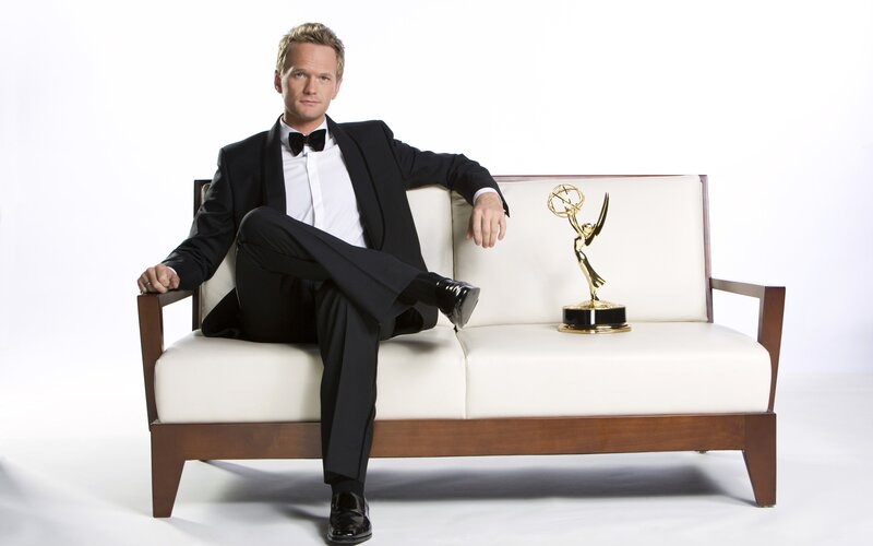 Man in tuxedo with Emmy award