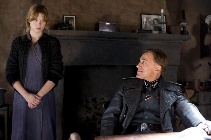 Man in uniform with woman by fireplace