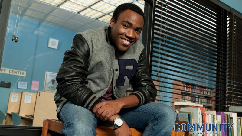 man in varsity jacket smiling
