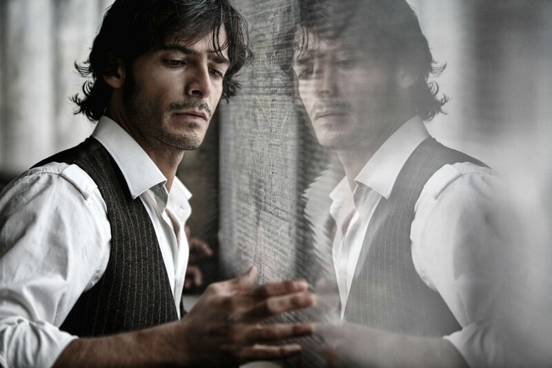 Man in Vest Looking at Reflection
