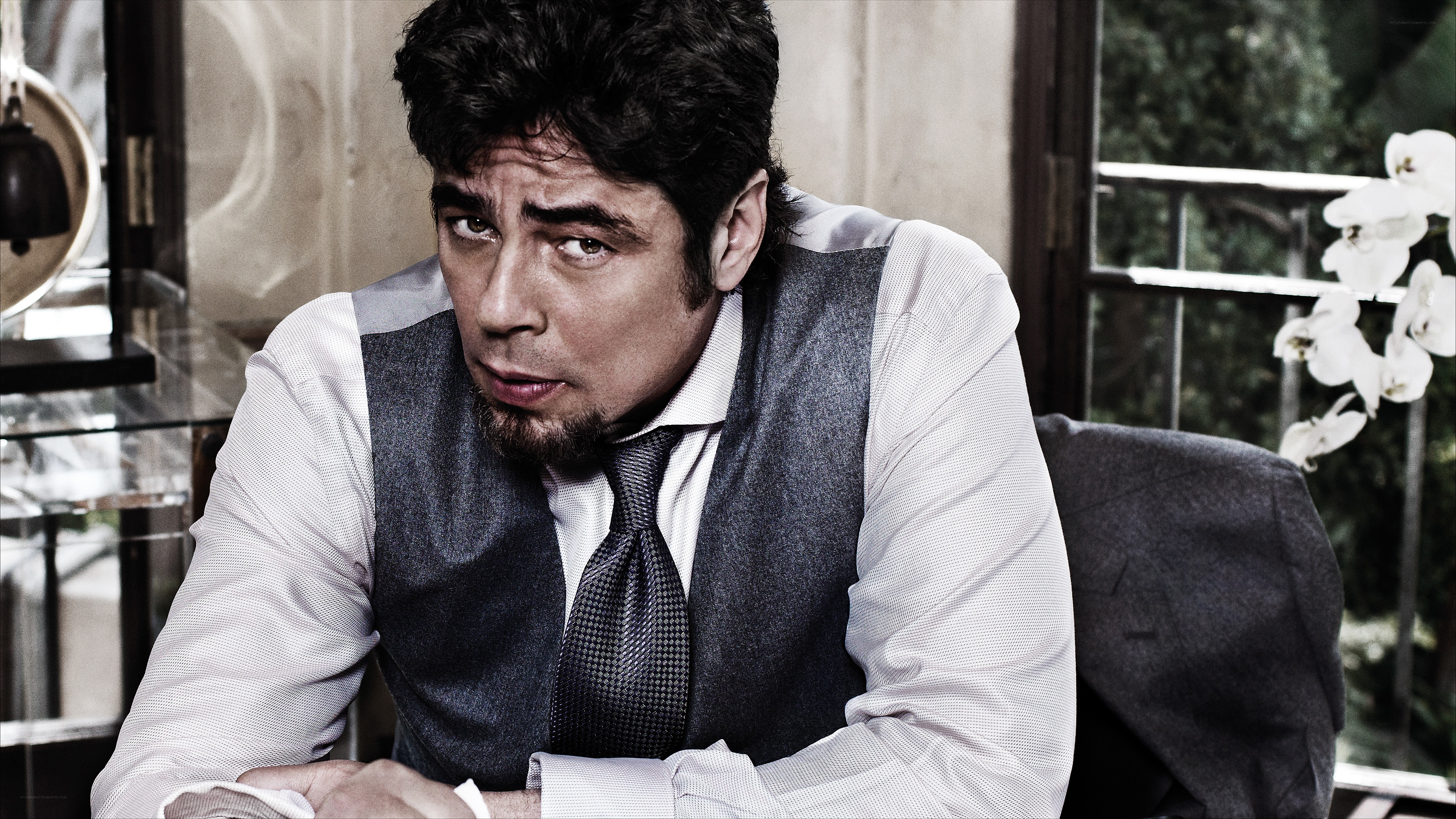 man in vest looking serious