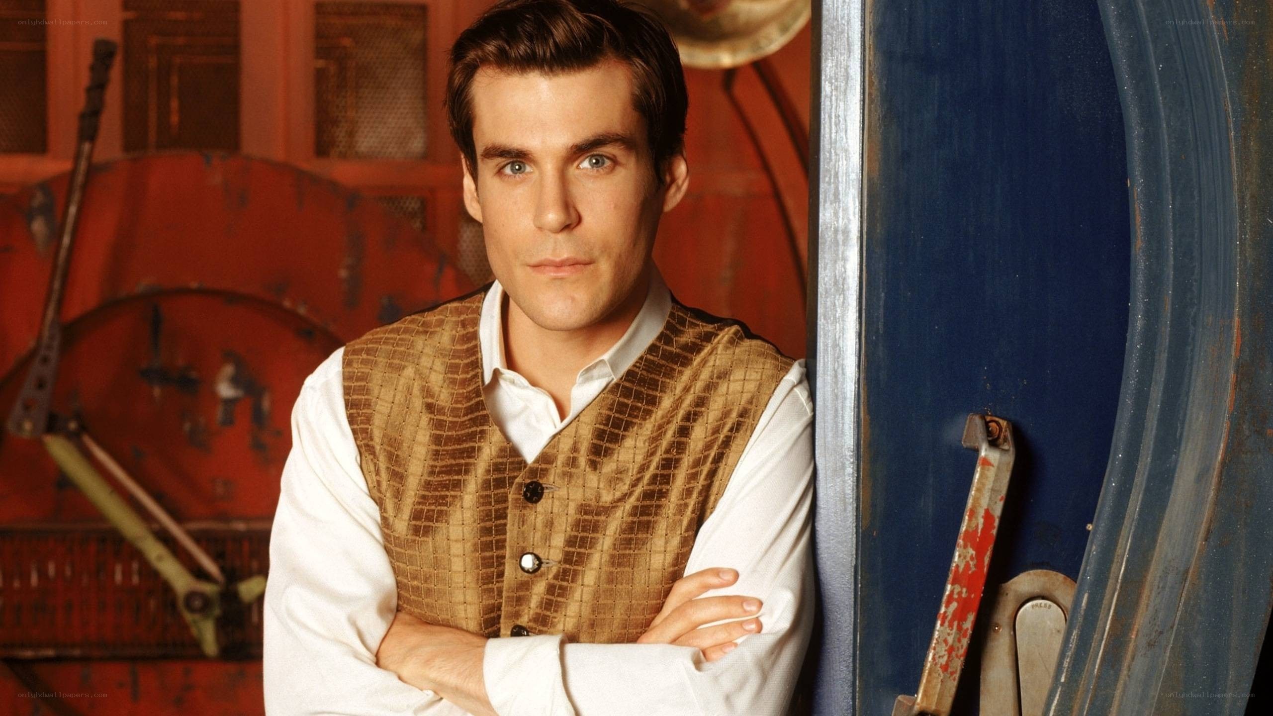 man in vest with arms crossed