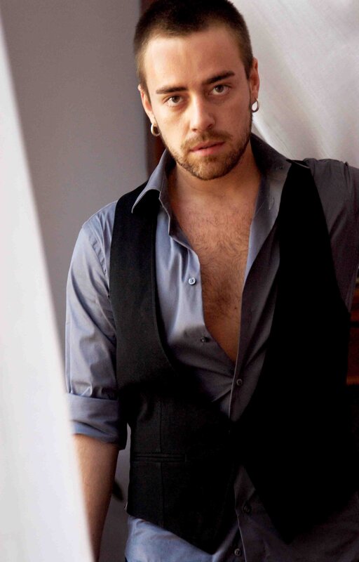 man in vest with open shirt