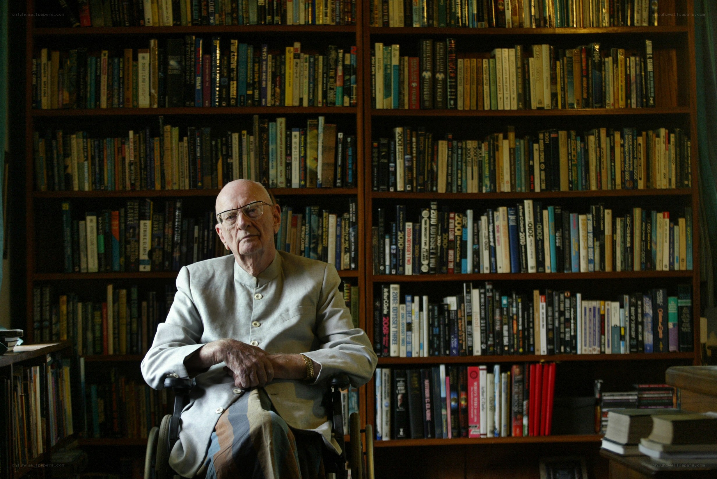Man in wheelchair with bookshelf