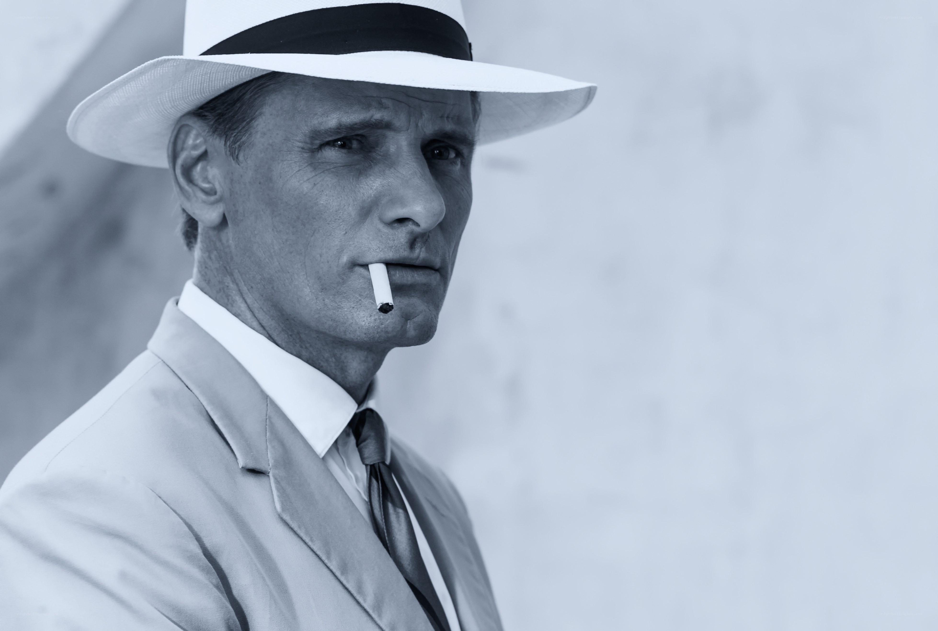 man in white hat with cigarette