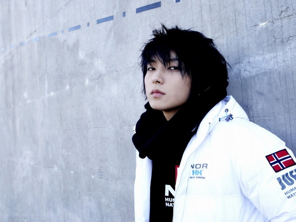 man in white jacket against concrete wall