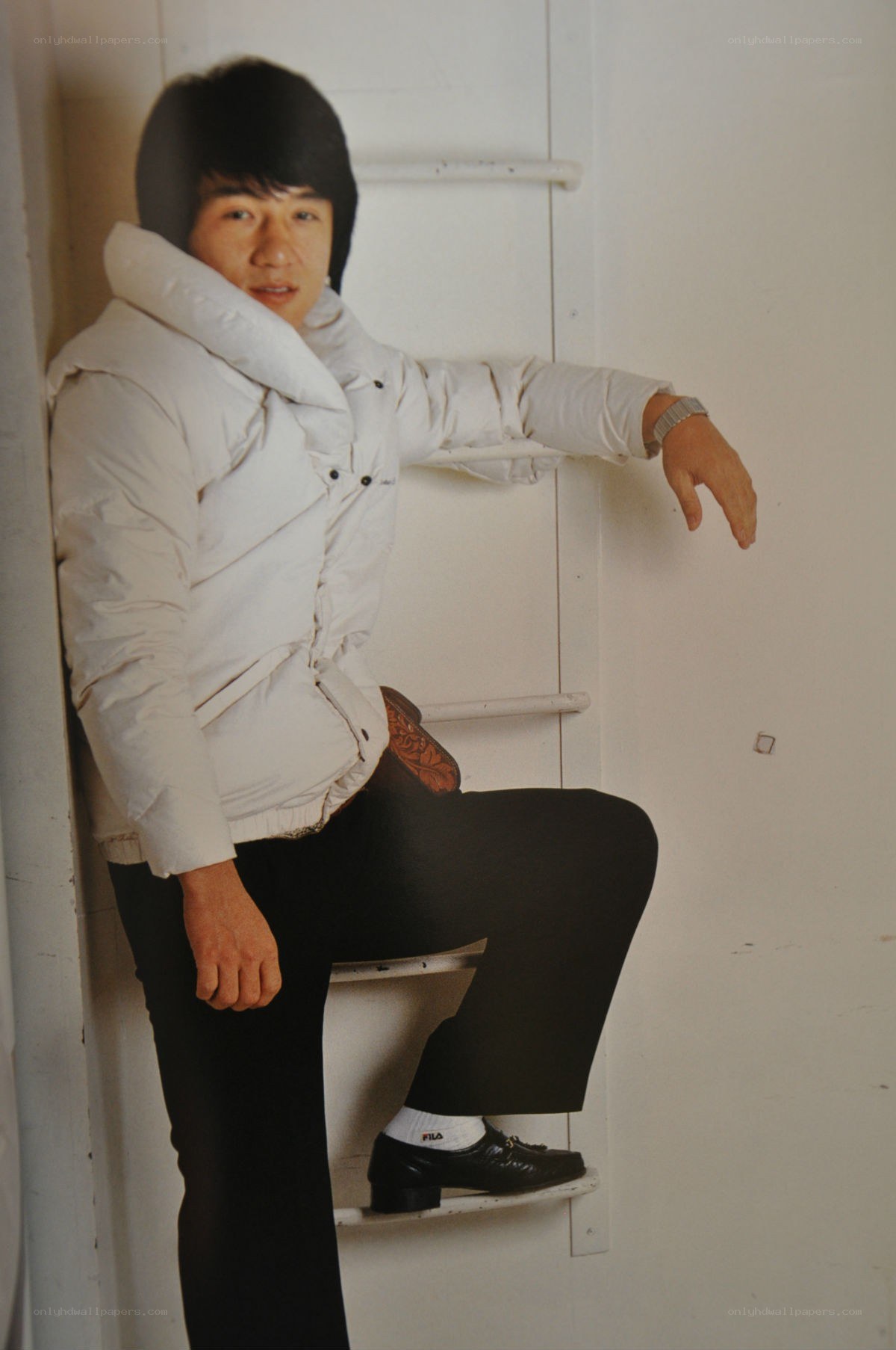 man in white jacket sitting on stairs