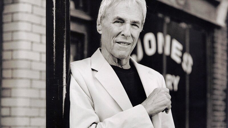Man in white jacket smiling