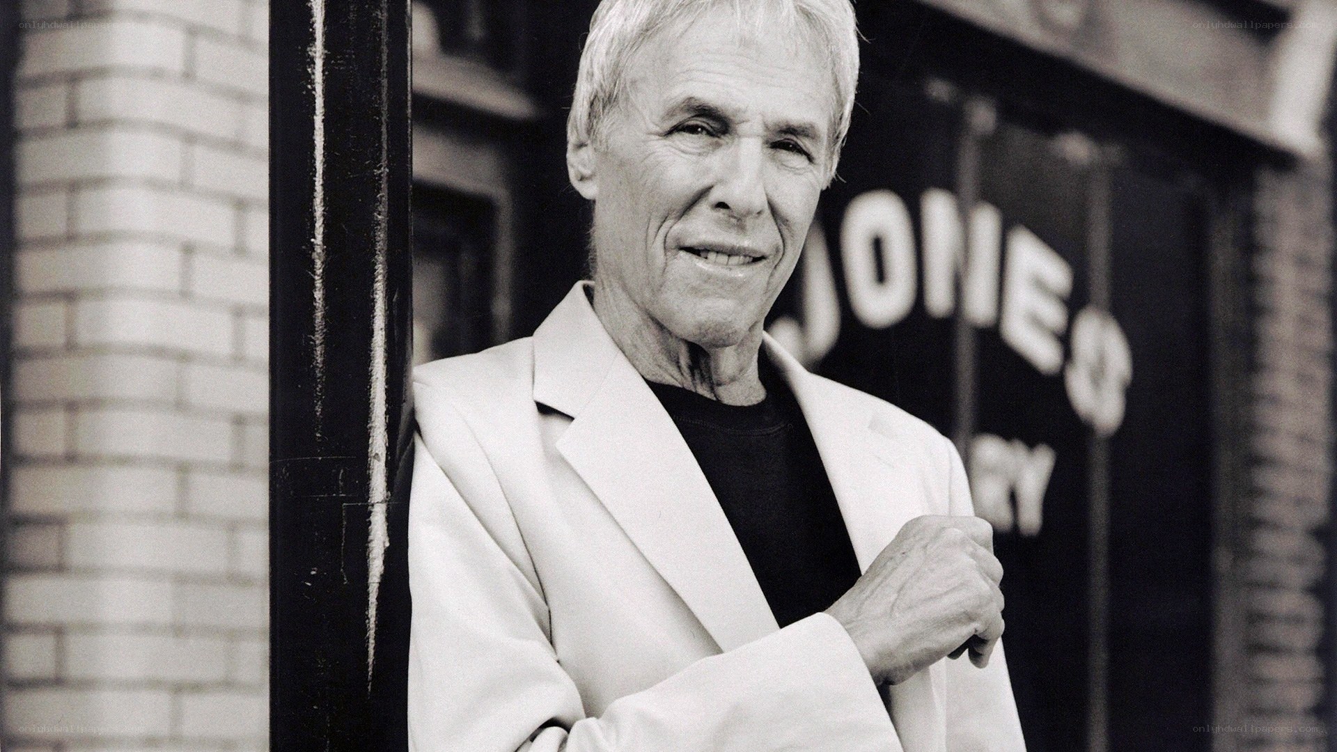 Man in white jacket smiling
