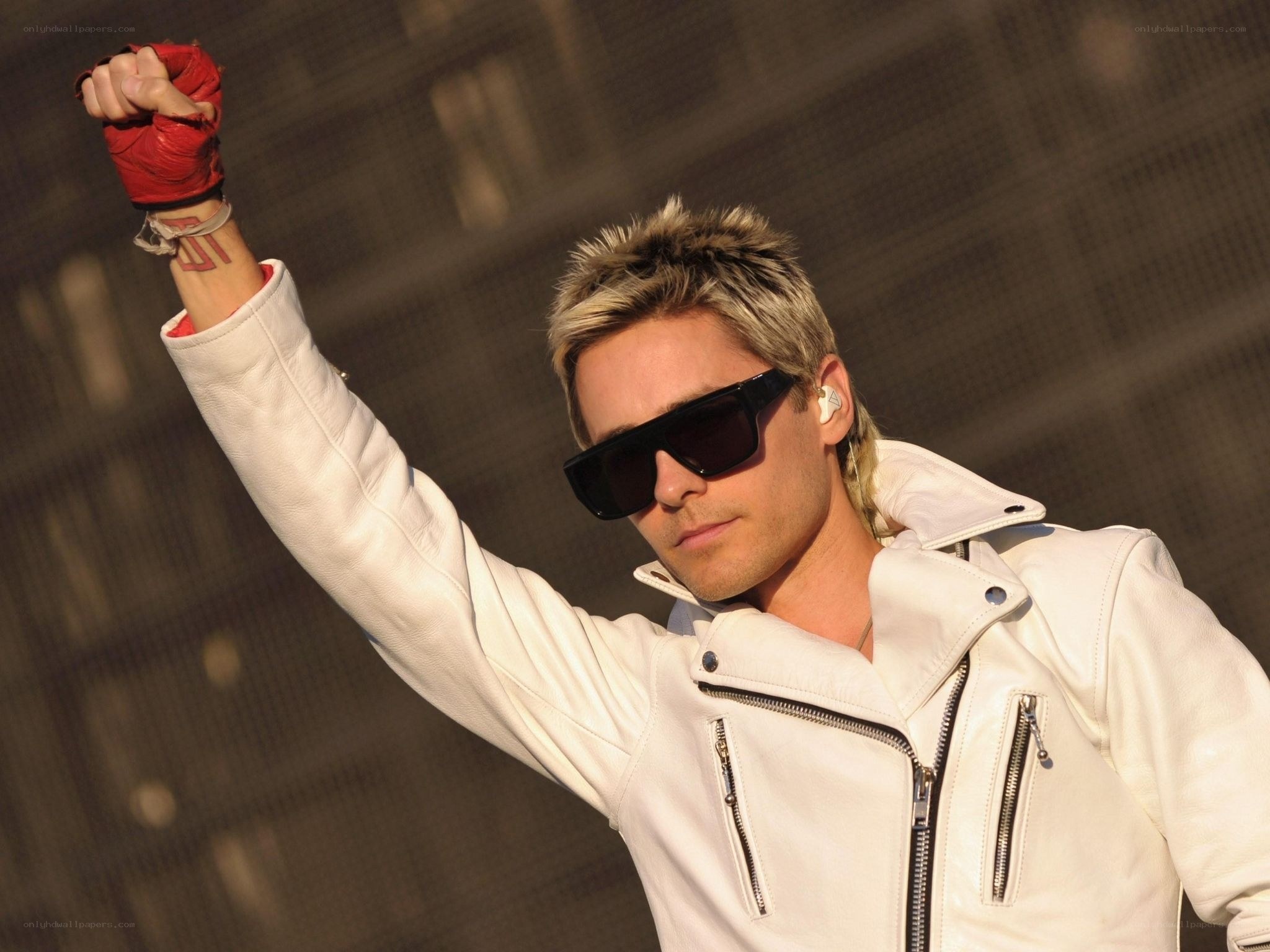 man in white jacket with fist raised