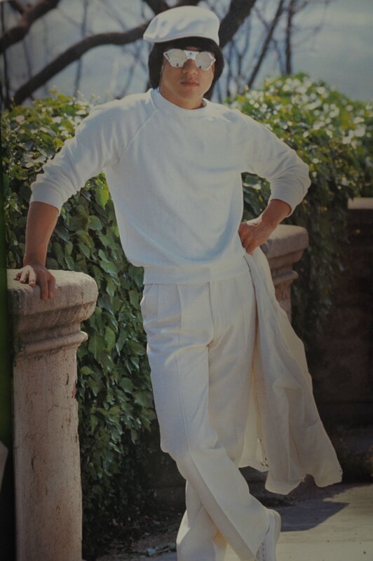 man in white outfit posing
