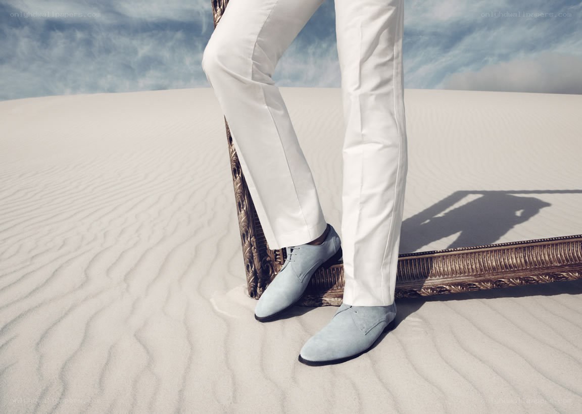 Man in white pants on sand