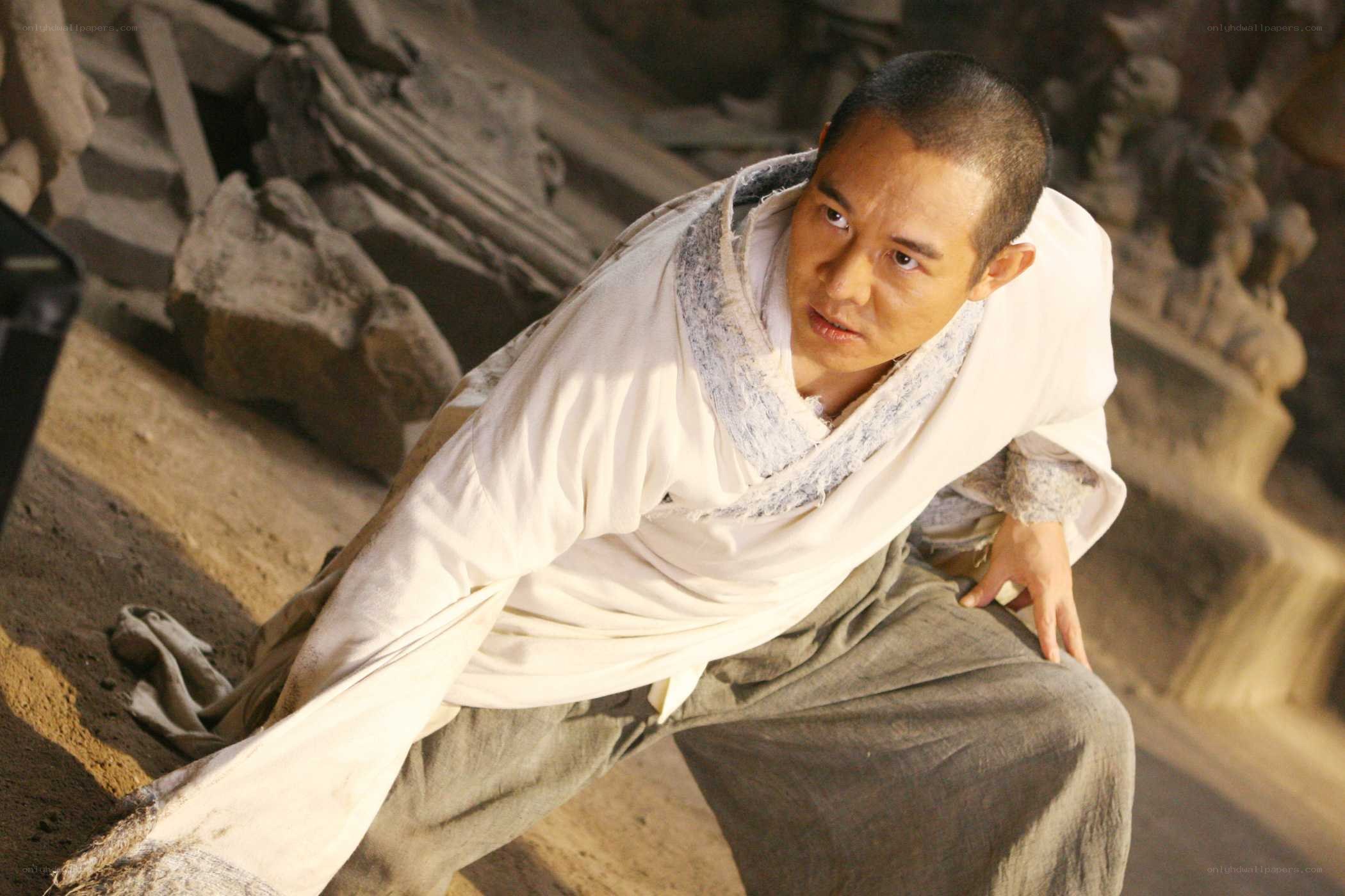 man in white robe crouching