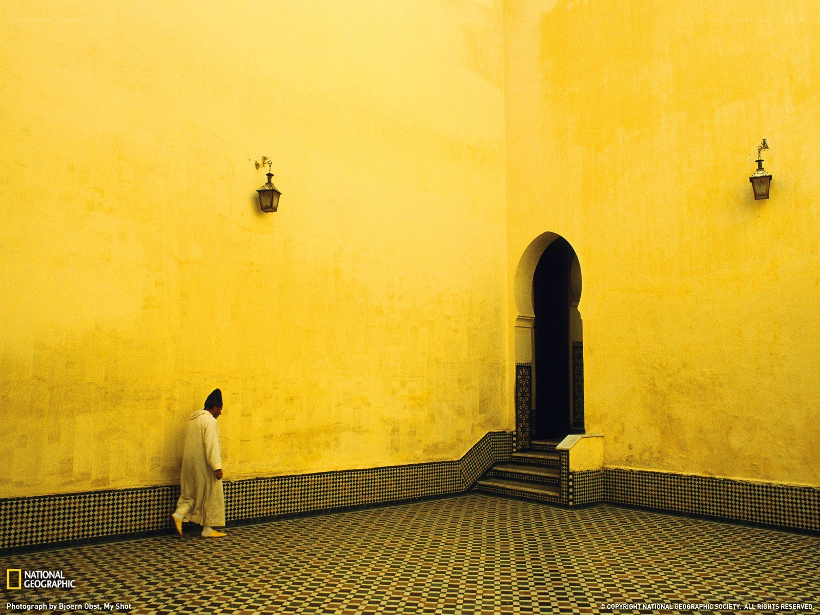 Man in white robe walking