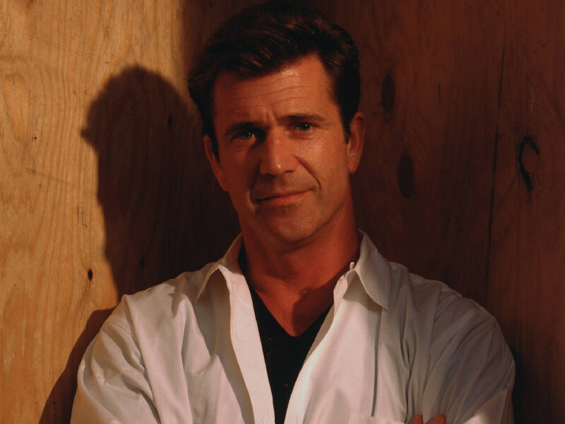 man in white shirt against wood