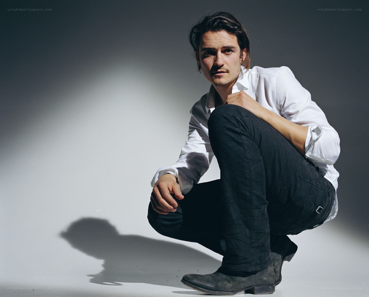 man in white shirt crouching