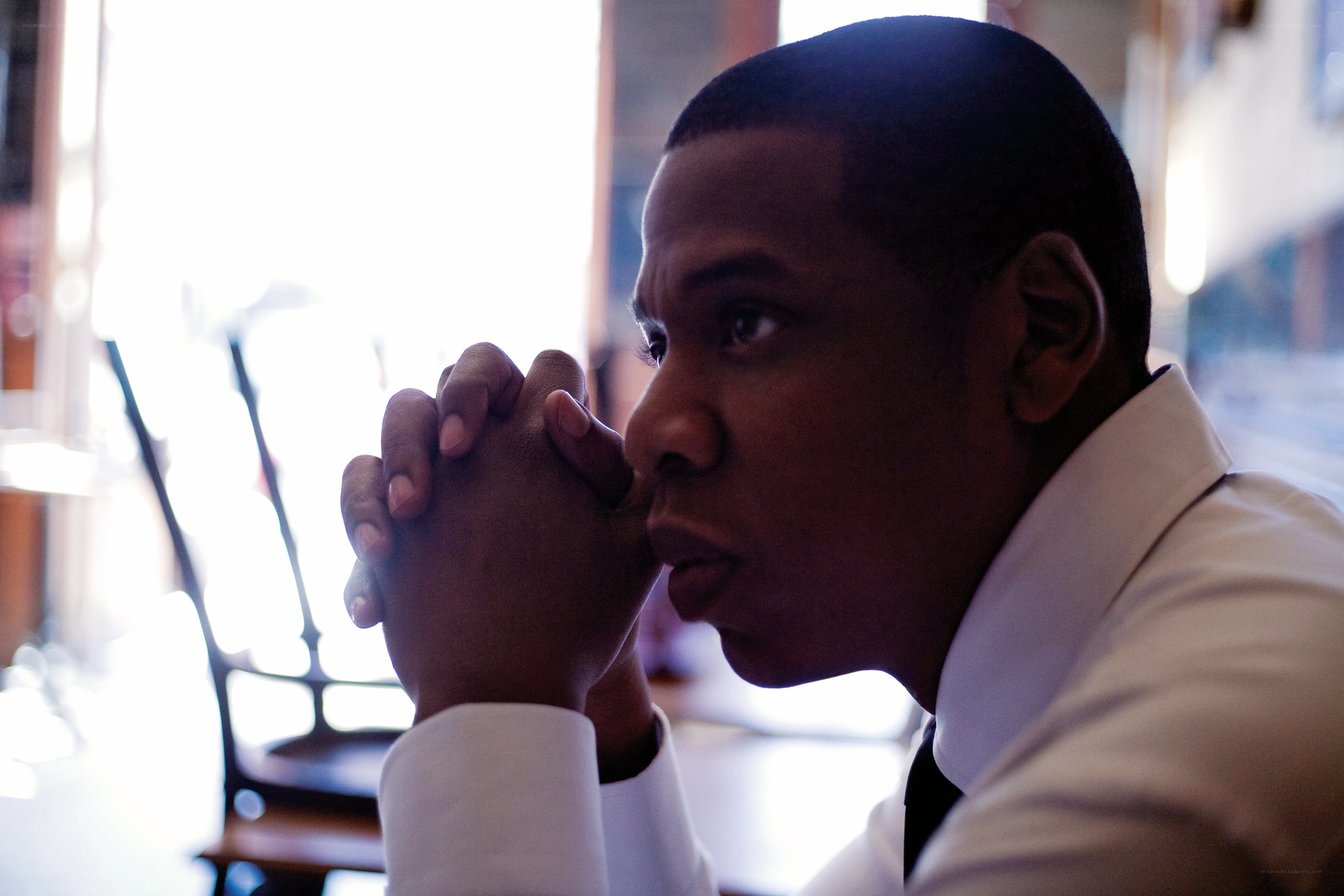 man in white shirt looking thoughtful