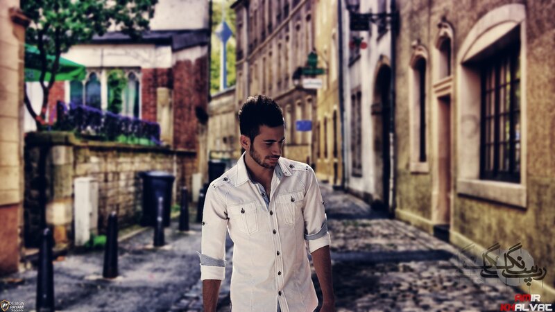 man in white shirt on cobblestone street
