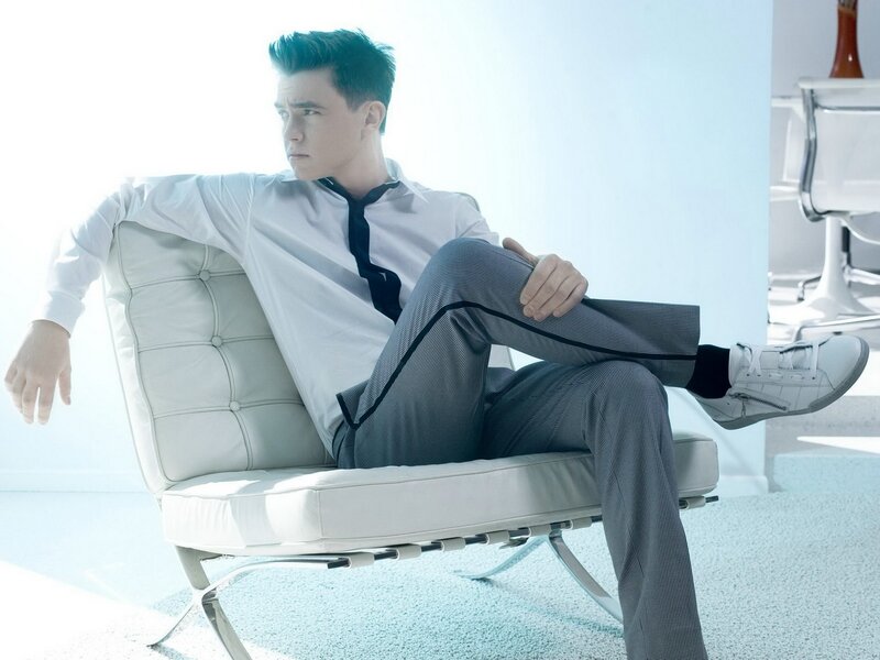 man in white shirt sitting